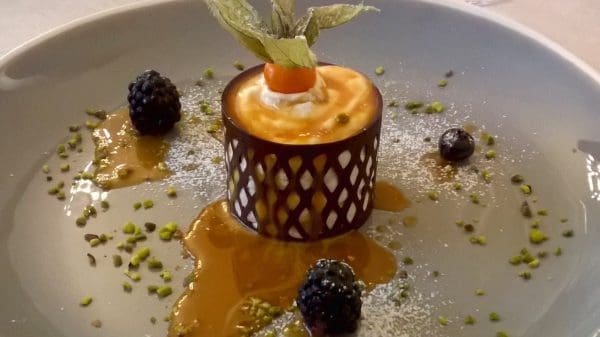 Parfait av torrone med sjokolade og karamell. En bløt iskrem laget av fransk nougat i et mørkt sjokoladegitter på en fløtekaramellsaus.